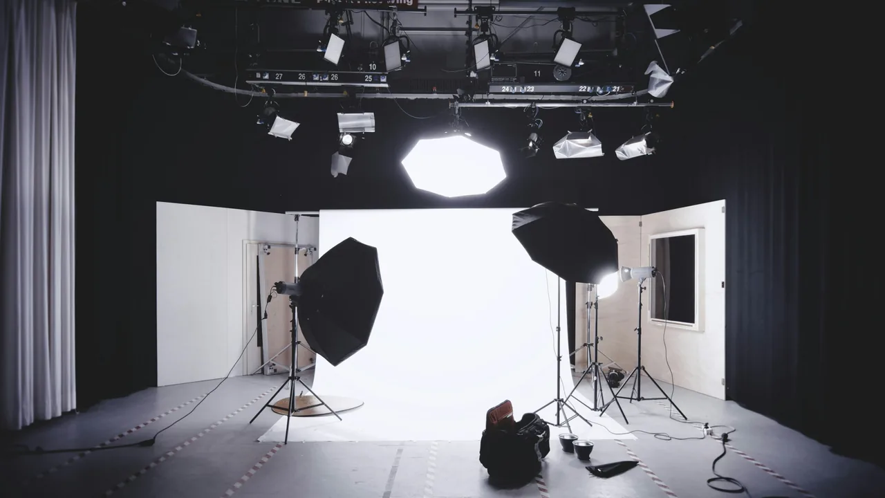 Photography studio with lighting stands and a white backdrop