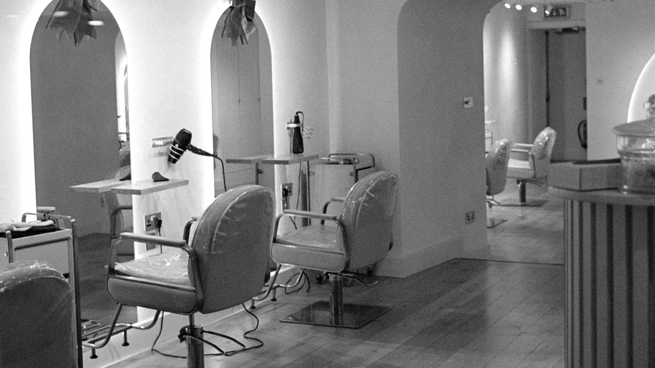 Empty styling chairs and mirrors in a hair salon