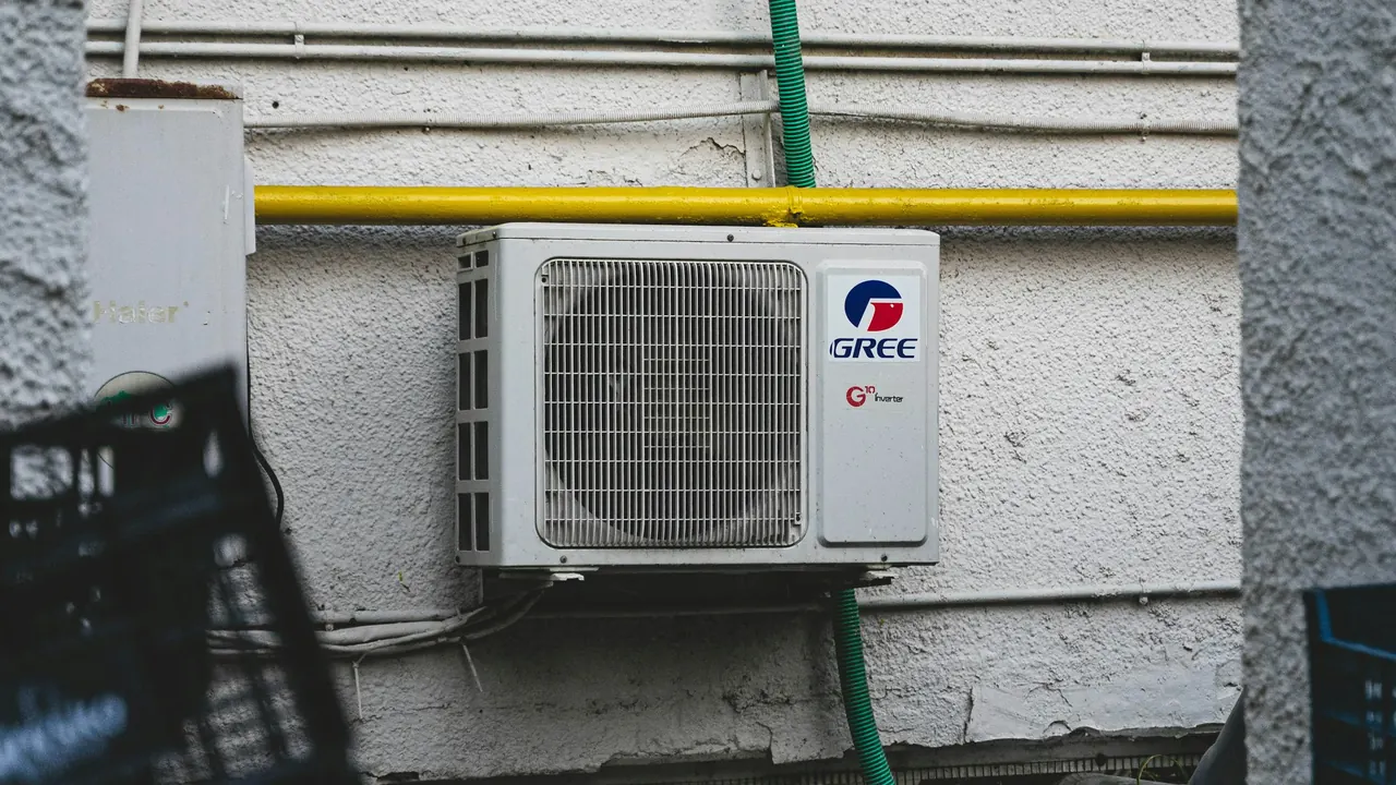 Wall-mounted outdoor air-conditioning equipment above stacked crates
